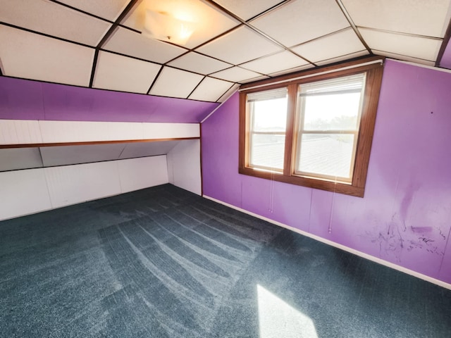 additional living space with lofted ceiling and dark carpet