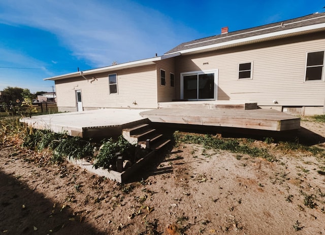 back of property with a wooden deck