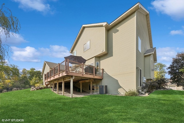 rear view of property featuring a lawn, central air condition unit, and a deck