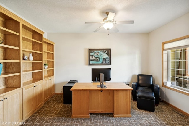 home office featuring ceiling fan and a textured ceiling