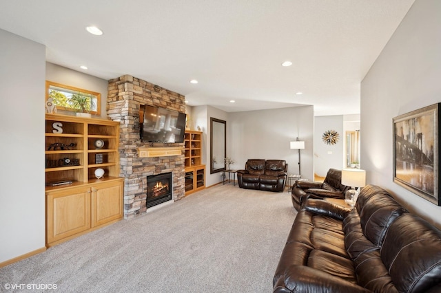 living room with carpet floors and a stone fireplace