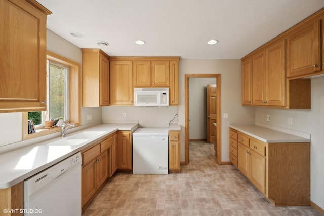 kitchen featuring sink and white appliances