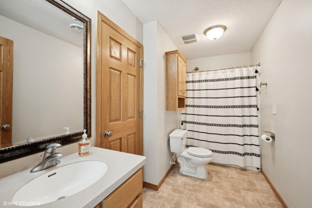 bathroom with a shower with curtain, vanity, toilet, and a textured ceiling