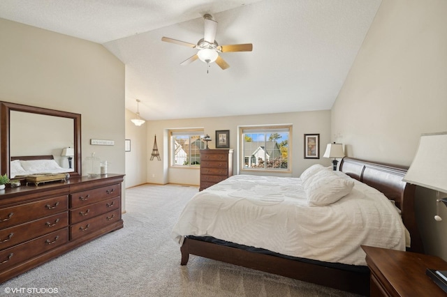 bedroom with a textured ceiling, ceiling fan, light colored carpet, and lofted ceiling