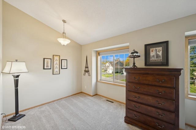 misc room with lofted ceiling and light carpet