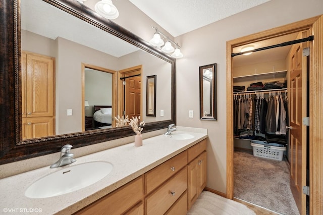 bathroom with a textured ceiling and vanity