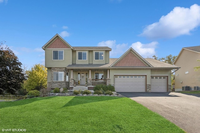 craftsman house with covered porch, central AC, a garage, and a front lawn