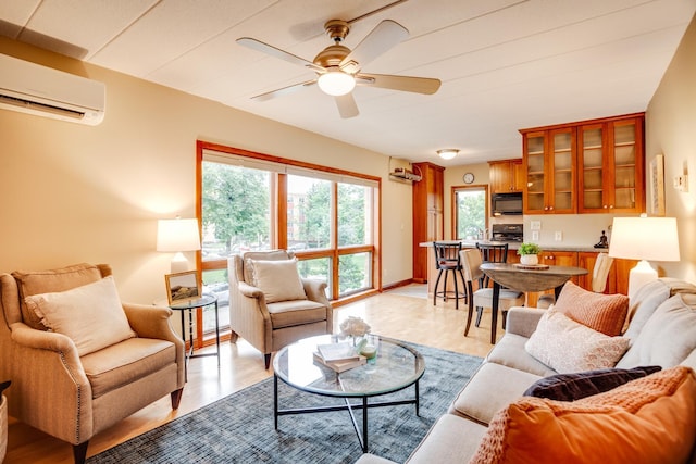 living room with a wealth of natural light, an AC wall unit, and ceiling fan