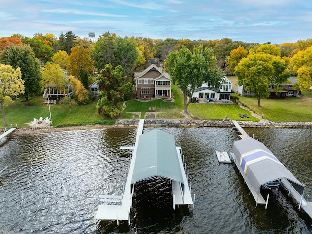 view of dock with a water view and a yard