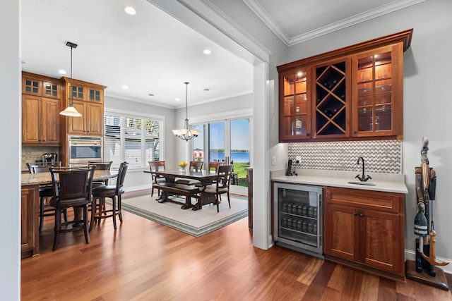 2172 Shadywood Rd, Orono, MN 55391 - indoor wet bar with wine cooler, oven, dark wood-style floors, backsplash, and recessed lighting