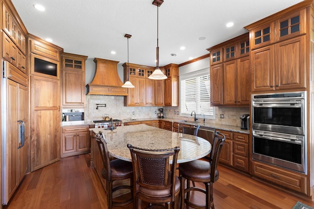 2172 Shadywood Rd, Orono, MN 55391 - kitchen with custom exhaust hood, stainless steel appliances, a kitchen island with sink, dark wood-style floors, and recessed lighting