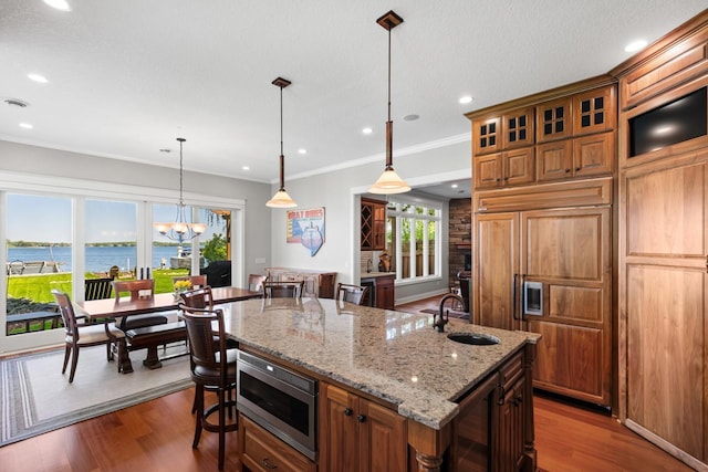 2172 Shadywood Rd, Orono, MN 55391 - kitchen with a sink, built in appliances, a kitchen island with sink, dark wood-type flooring, and a breakfast bar area