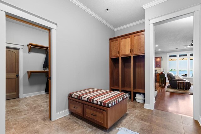 2172 Shadywood Rd, Orono, MN 55391 - mudroom featuring crown molding, a textured ceiling, a ceiling fan, and baseboards