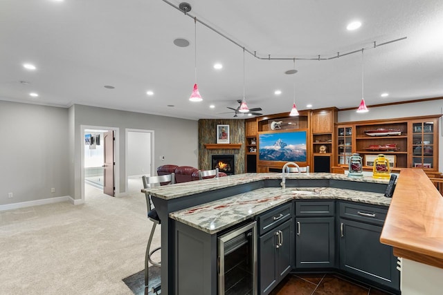 2172 Shadywood Rd, Orono, MN 55391 - kitchen with wine cooler, a sink, open floor plan, ceiling fan, and a large fireplace