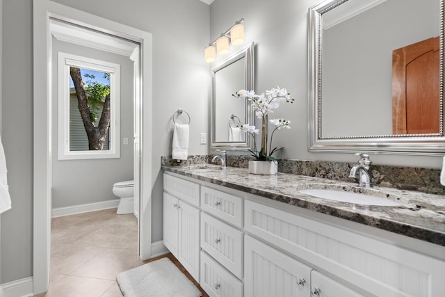 2172 Shadywood Rd, Orono, MN 55391 - full bath featuring baseboards, tile patterned flooring, double vanity, and toilet