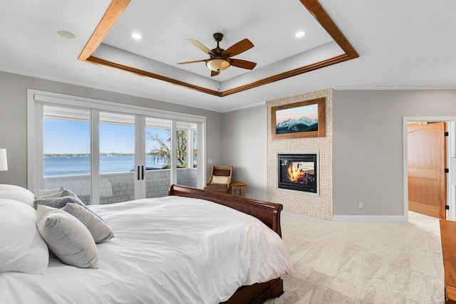 2172 Shadywood Rd, Orono, MN 55391 - bedroom featuring access to exterior, a raised ceiling, crown molding, a large fireplace, and a water view