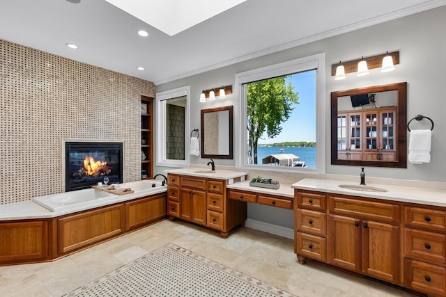 2172 Shadywood Rd, Orono, MN 55391 - bathroom featuring crown molding, vanity, a glass covered fireplace, a bath, and recessed lighting