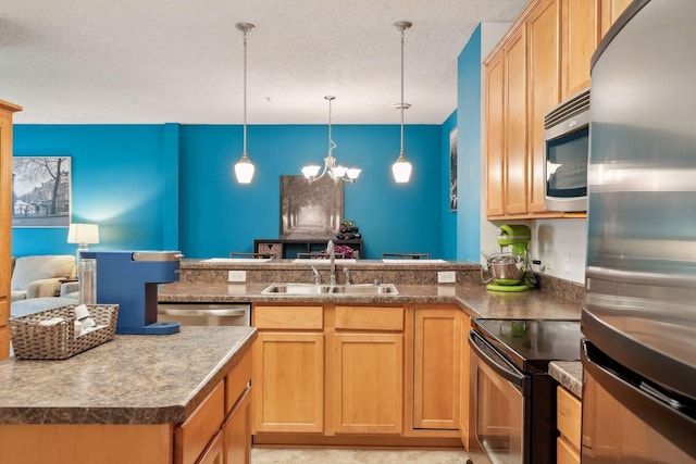 kitchen with an inviting chandelier, pendant lighting, sink, stainless steel appliances, and a textured ceiling