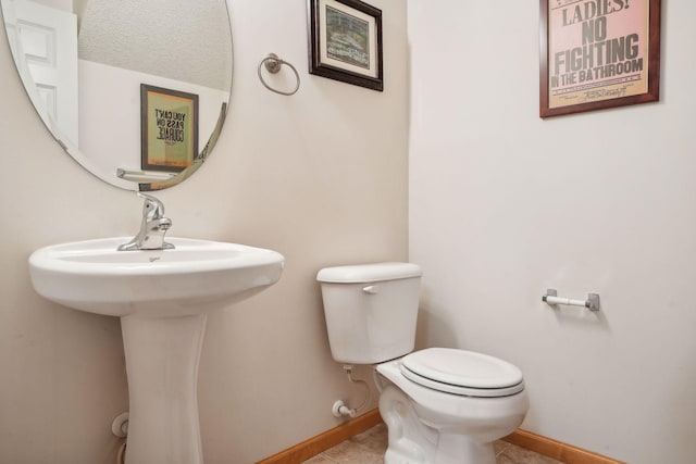 bathroom with tile patterned floors, toilet, and a textured ceiling