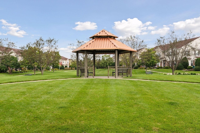 surrounding community with a gazebo and a yard