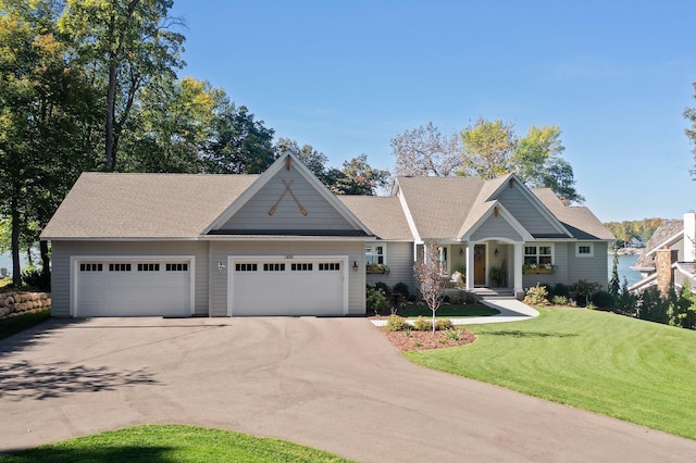 craftsman house featuring a garage and a front lawn