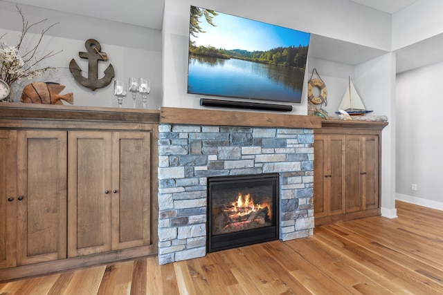 room details with a fireplace and hardwood / wood-style floors