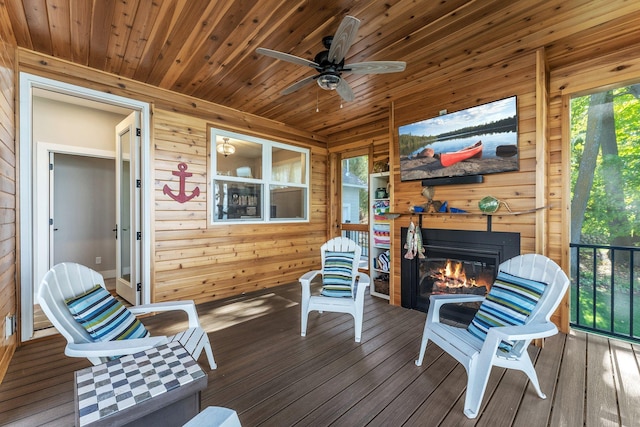 sunroom / solarium featuring ceiling fan and wood ceiling