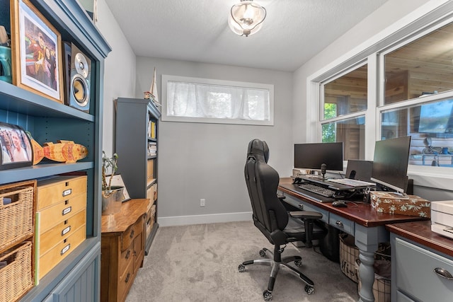 office featuring a textured ceiling and light carpet