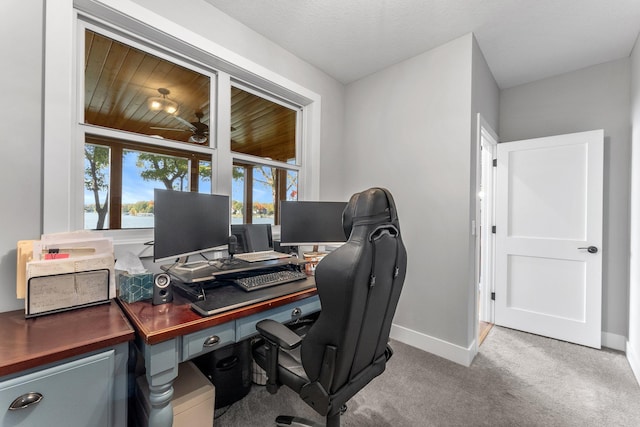 carpeted office space with a textured ceiling and wooden ceiling