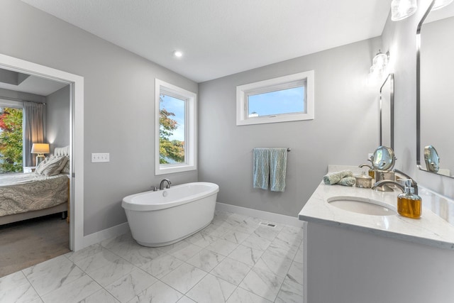 bathroom featuring a washtub and vanity