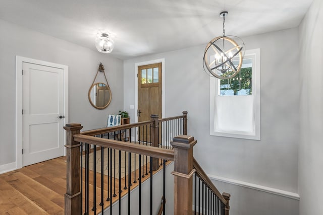 interior space featuring a wealth of natural light, an inviting chandelier, and light hardwood / wood-style floors