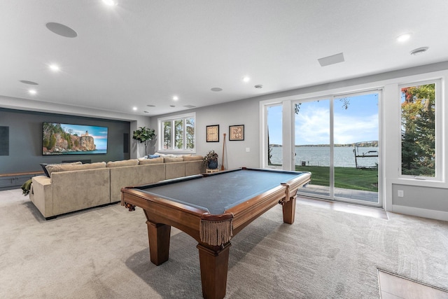 game room featuring light carpet, pool table, and a water view