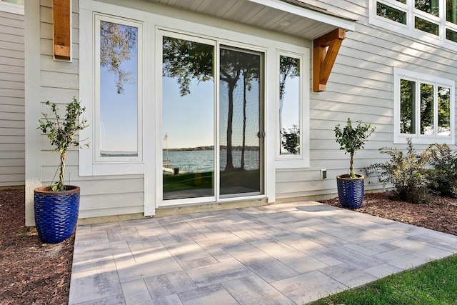 view of exterior entry with a patio