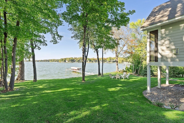 view of yard with a water view and a dock