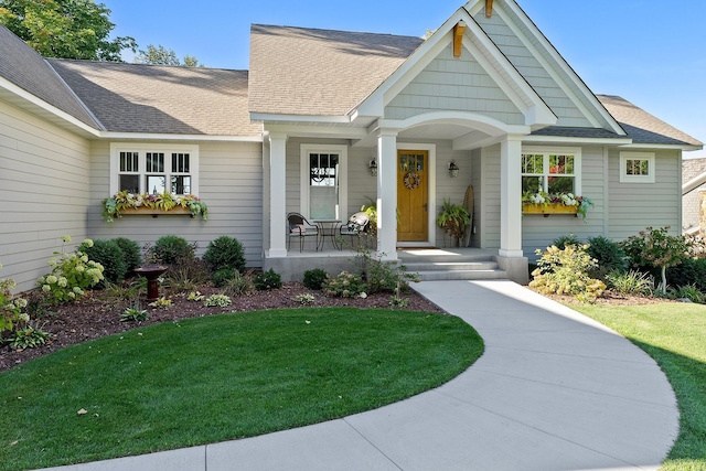 view of front of property with a porch and a front yard