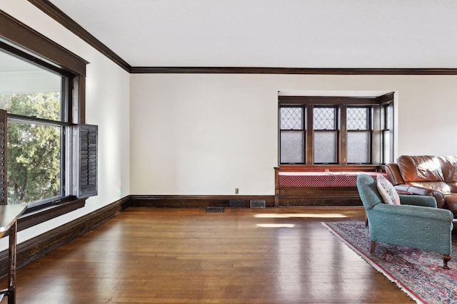 living room featuring wood-type flooring and ornamental molding