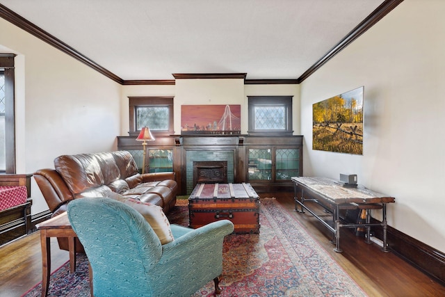 living room with crown molding, a healthy amount of sunlight, and hardwood / wood-style flooring