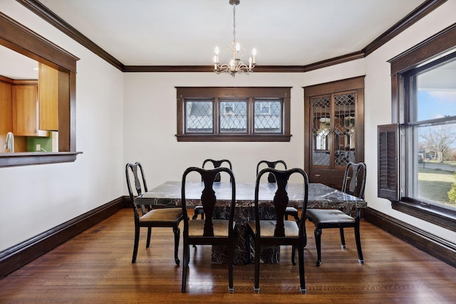 dining area with ornamental molding, dark wood-type flooring, and a notable chandelier