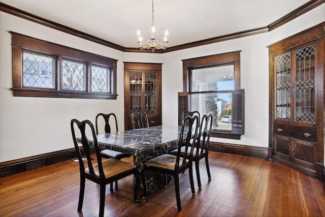 dining space featuring ornamental molding, dark wood-type flooring, and a notable chandelier