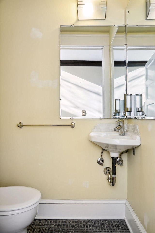 bathroom featuring tile patterned floors and toilet