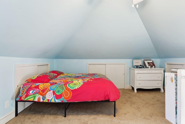 carpeted bedroom featuring vaulted ceiling