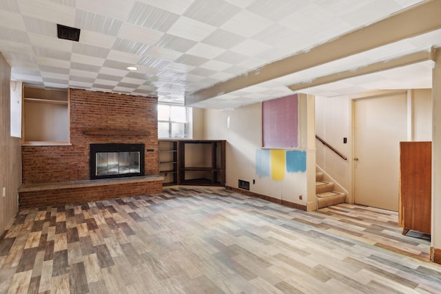 unfurnished living room with a fireplace and hardwood / wood-style floors