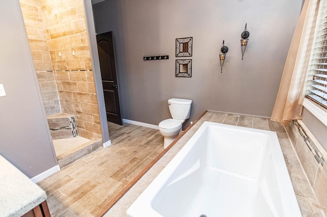 bathroom with hardwood / wood-style floors, toilet, and a tub