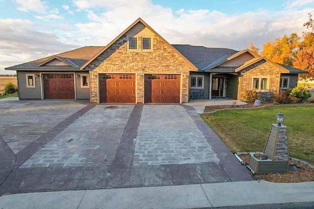 view of front of home featuring a garage and a front lawn