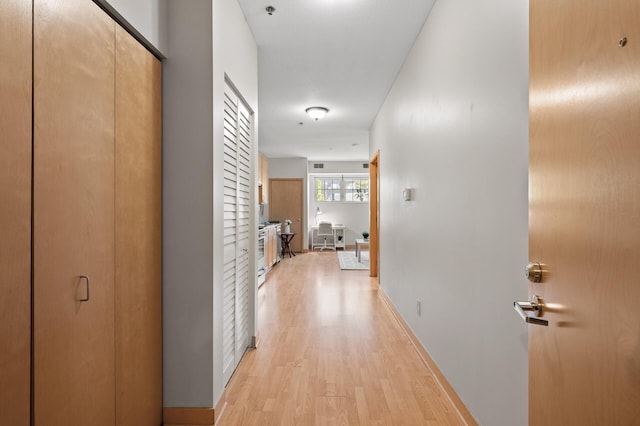 hall with light hardwood / wood-style floors