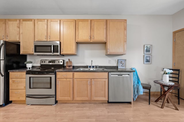 kitchen featuring light brown cabinetry, sink, appliances with stainless steel finishes, and light wood-type flooring