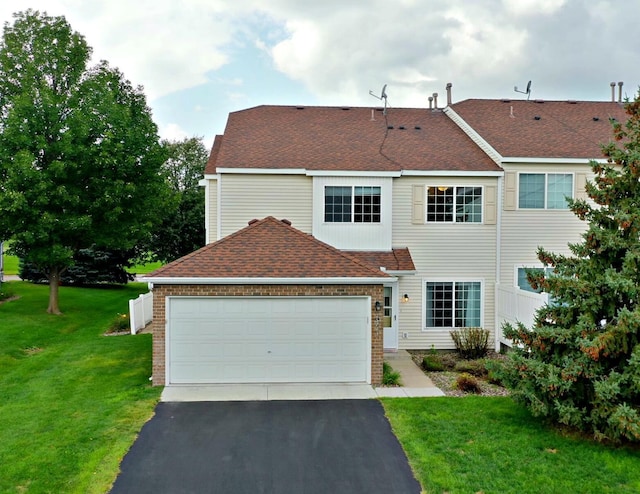 view of front of house featuring a garage and a front yard