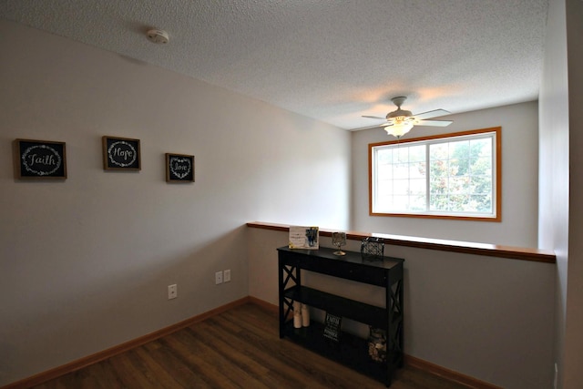 spare room with ceiling fan, dark hardwood / wood-style floors, and a textured ceiling