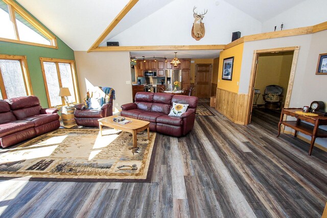 living room with wooden walls, dark hardwood / wood-style flooring, and high vaulted ceiling