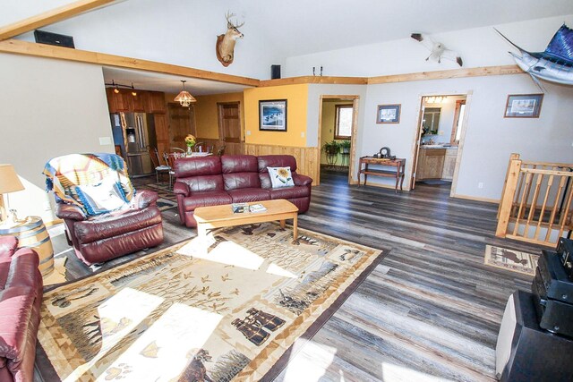 living room featuring dark wood-type flooring and high vaulted ceiling